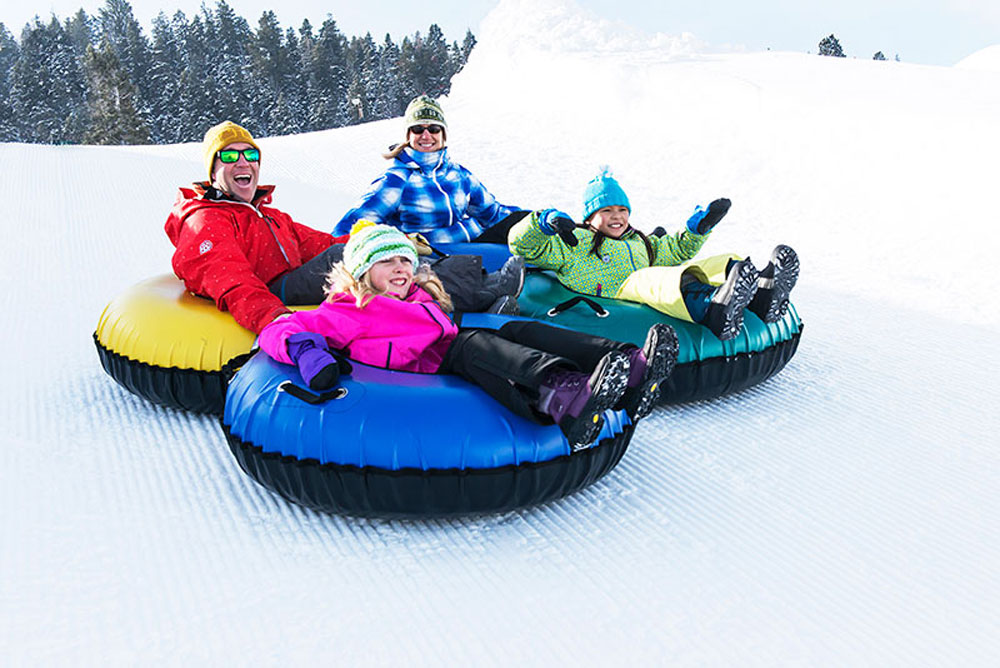 Family Tubing Down Slope in Park City