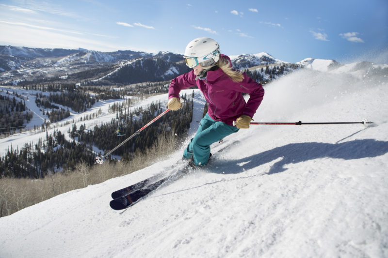 woman skiing on a bluebird day in park city utah
