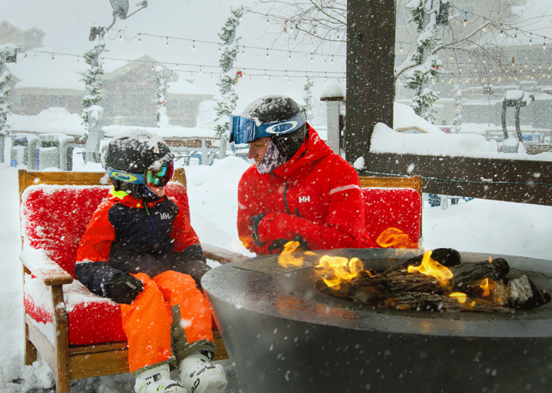 Father and Son Sitting by a Fire in a Snowstorm in Park City
