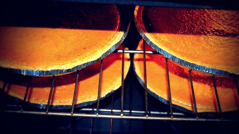 Pumpkin Pies Cooking in an Oven