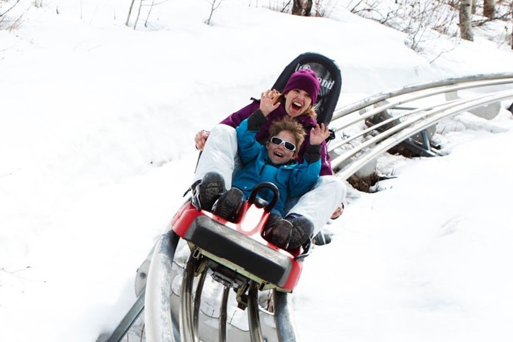 Mother and Child Riding Alpine Slide in the Winter