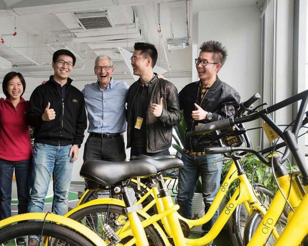 Group in front of yellow ride share bikes
