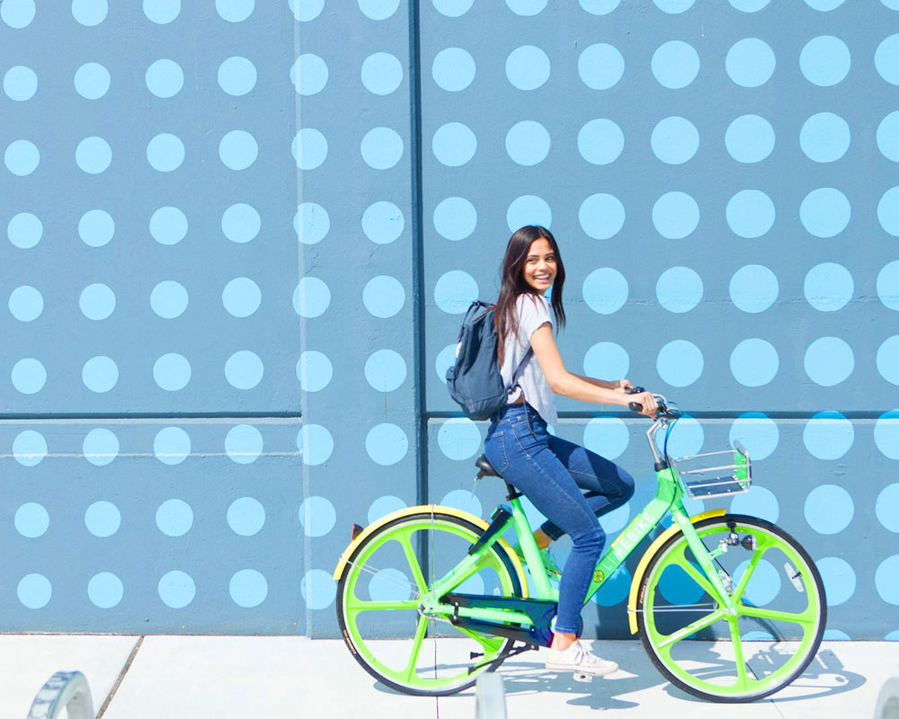 Woman smiling on lime bike