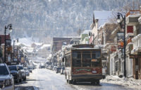 Trolley Driving Up Main Street Park City During Winter