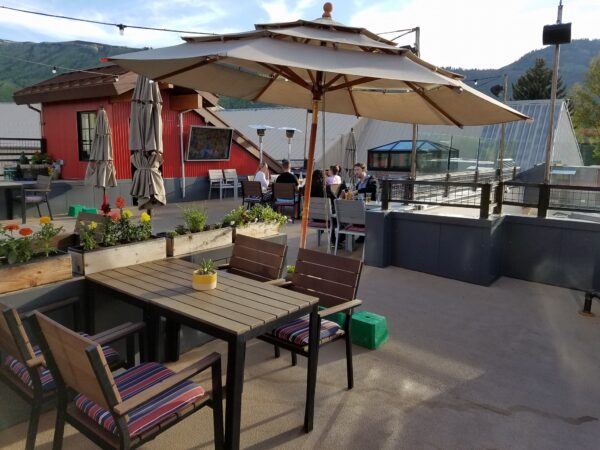 Friends Enjoying a Drink on Boneyard Saloon's Rooftop Patio in Park City