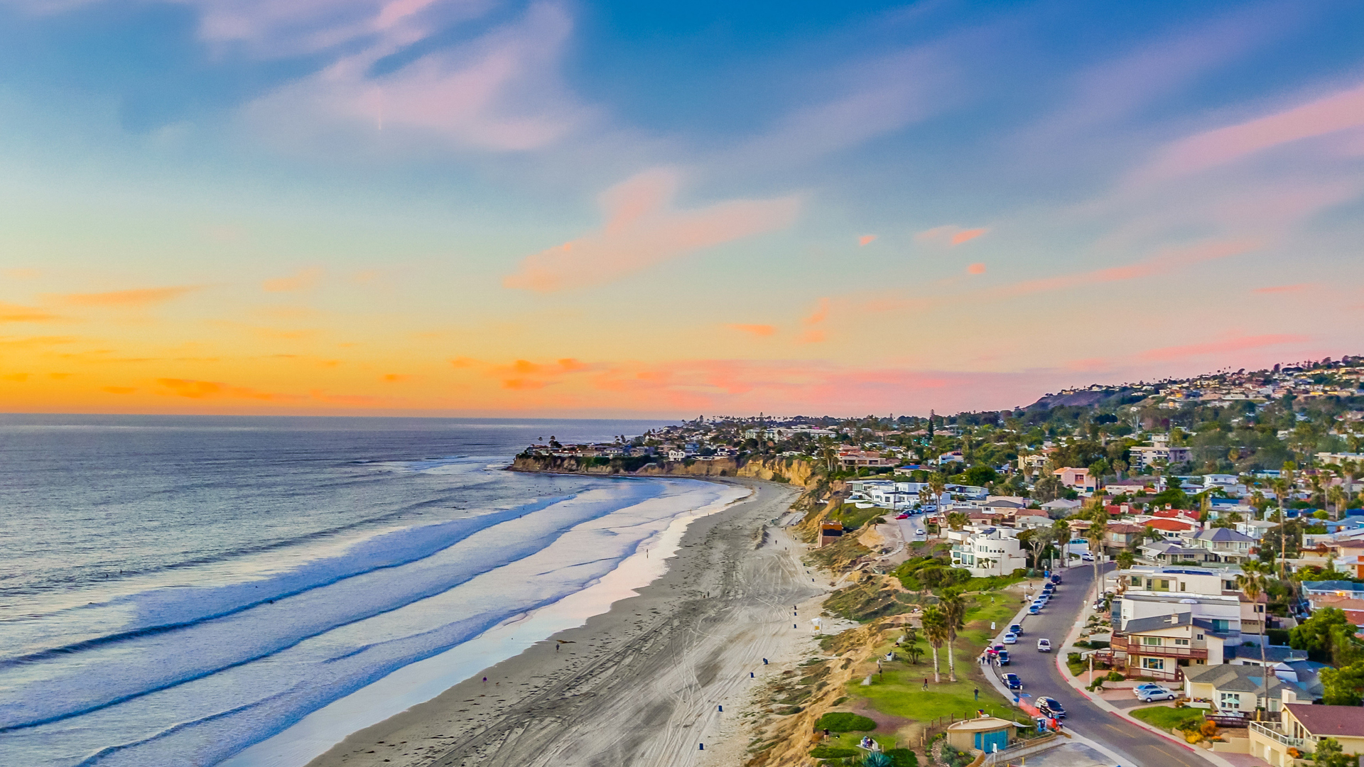 Waves Crashing to the Shore in Front of a Pink Sunset at Capri by the Sea in San Diego