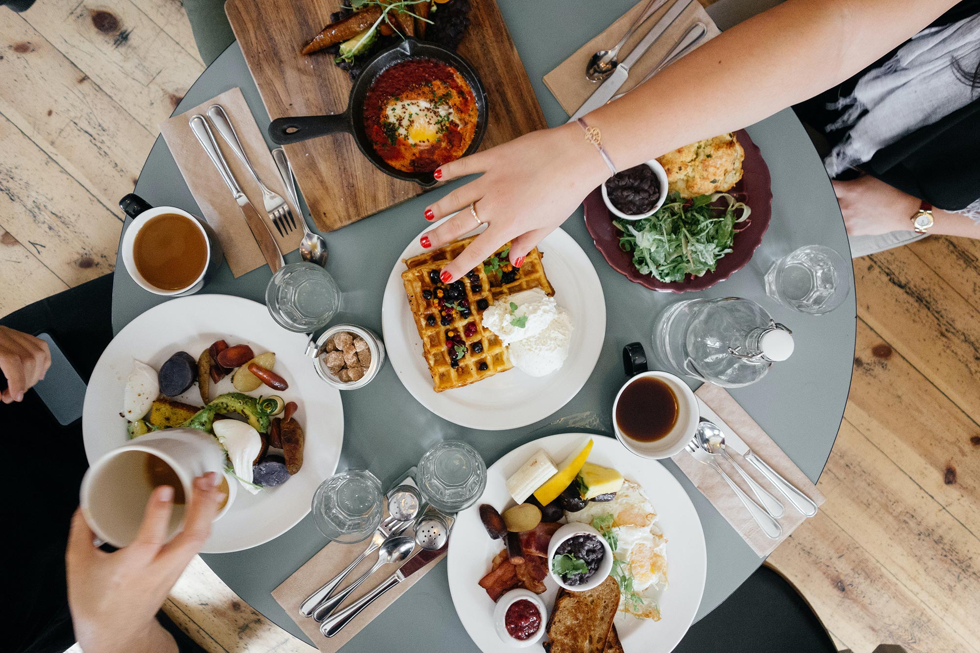 Aerial image of group enjoying a hearty breakfast at a circle table in Santa Fe