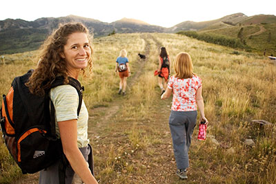 family hiking in park city in the golden hour