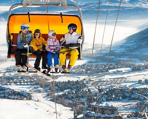 Family in Orange Bubble Lift Overlooking Canyons Village in Park City Utah