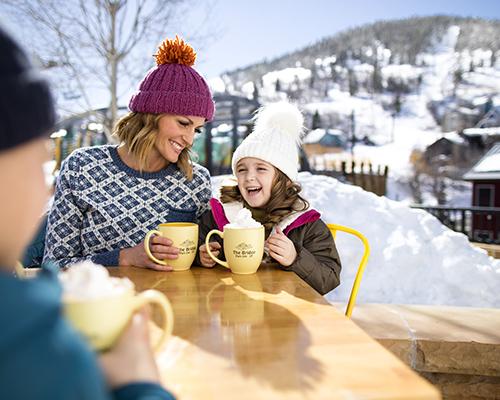 Family Enjoying Hot Chocolate on Main Street Park City