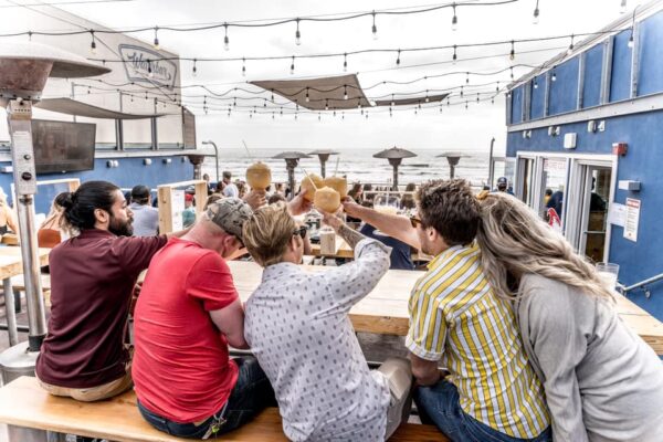 Friends at a table cheersing their glasses in San Diego