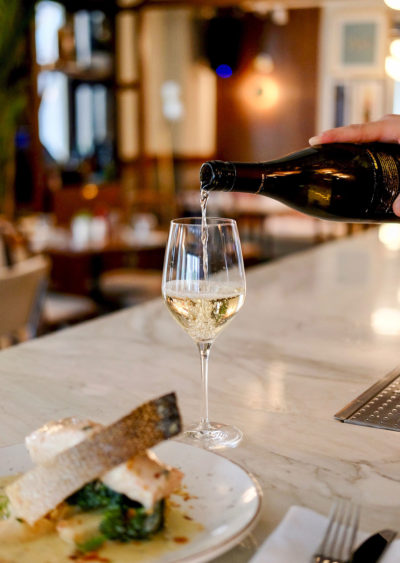 Glass of White Wine on a White Marble Bar