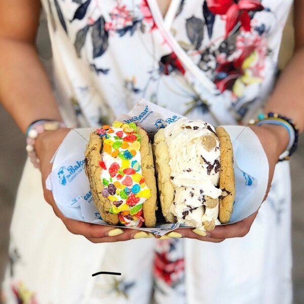 Woman holding overloaded ice cream sandwiches from The Baked Bear in San Diego