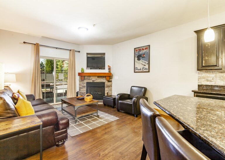 Living rooms hold fireplaces and patio access in 3-bedroom condos at Bear Hollow Village