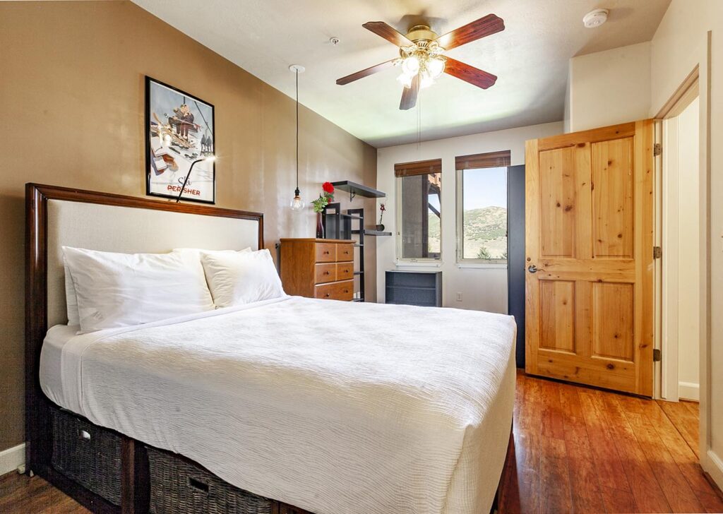 A bedroom in deluxe 2-bedroom condo at Crestview Condominiums