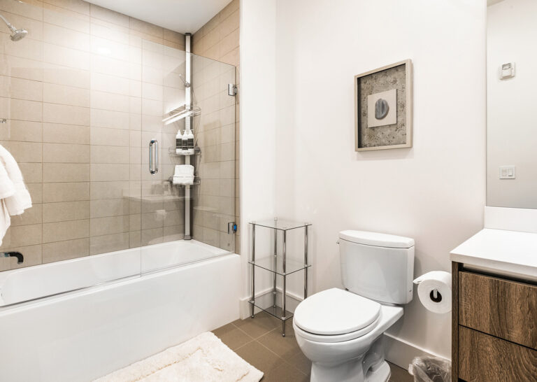shower tub combo and toilet in bedroom suite