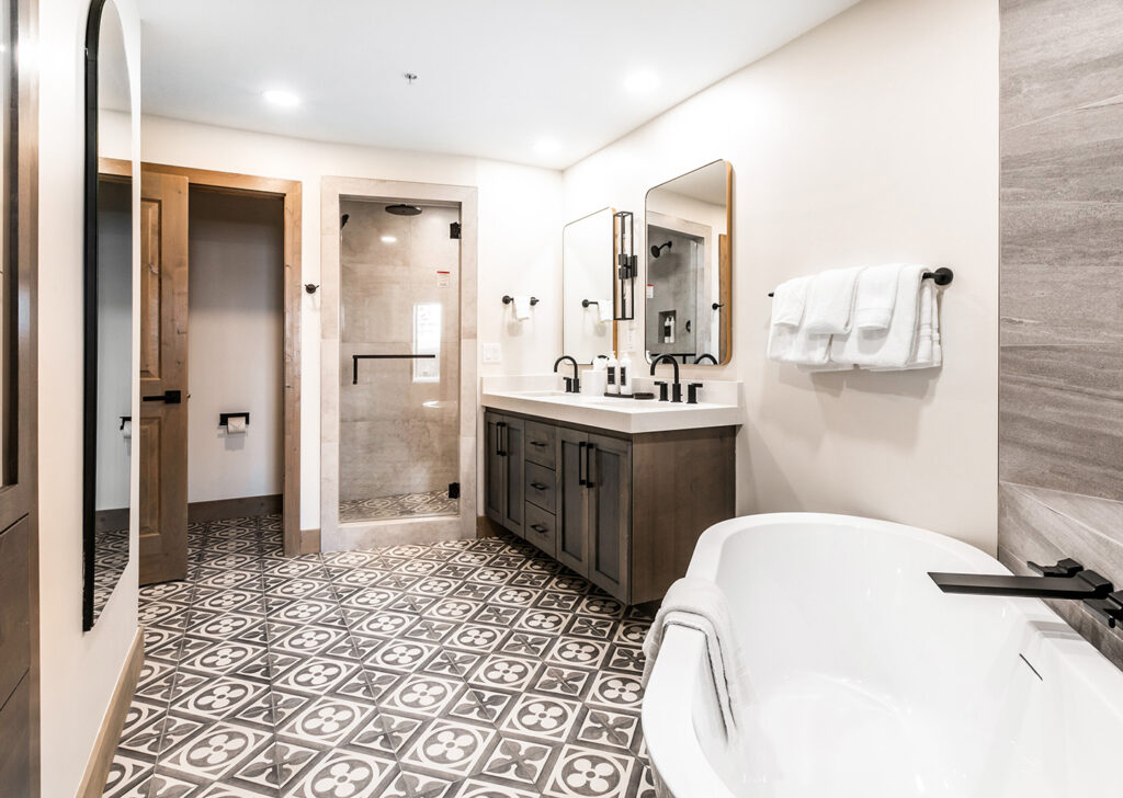 primary bathroom view of tub, shower, and vanity.