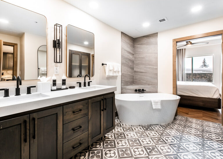 bathroom vanity with 2 sinks and a freestanding bathtub