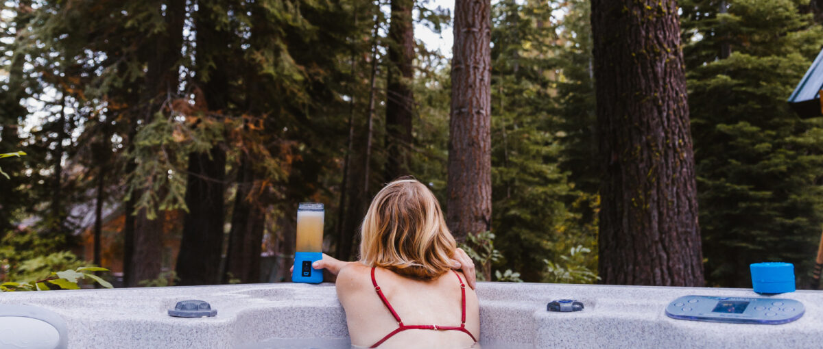 A Woman With A Drink Gazing into the Woods from her Hot Tub in Park City