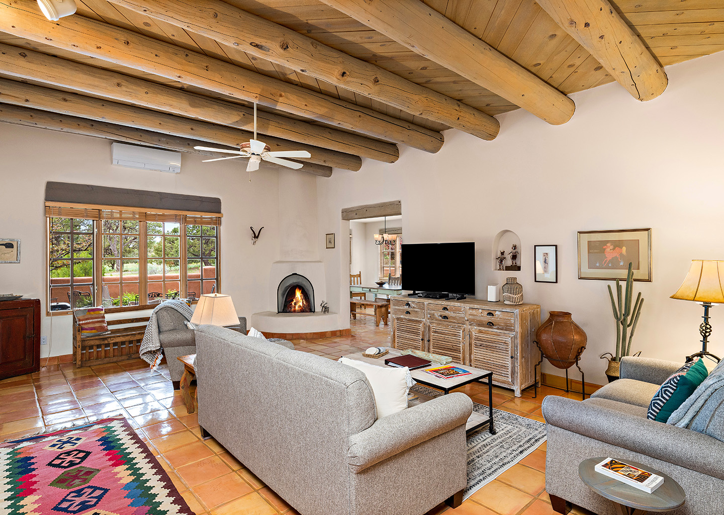 Living room with a kiva stove, a couch, loveseat, and chair