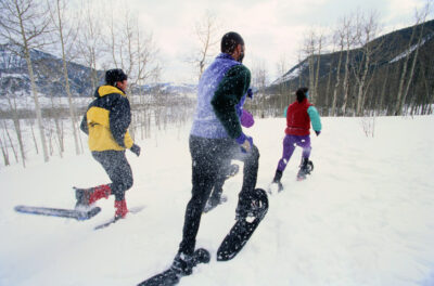 Snowshoers Racing Across a Snow Covered Field nowshoers Racing Across a Snow Covered Field