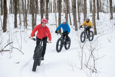 group of friends fat tire biking in snow