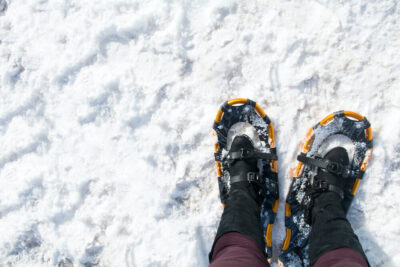 point of view looking down at snowshoes in fresh snow
