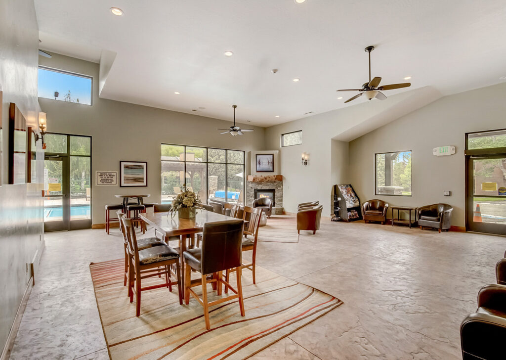 Park Avenue condominiums with a table, chairs and lounge area