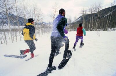 nowshoers Racing Across a Snow Covered Field