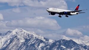 Delta Airlines plane above the Wasatch Mountains of Salt Lake City, Utah