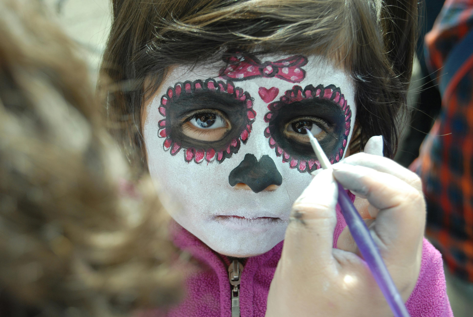 Family enjoying Dia de los Muertos festivities in Santa Fe