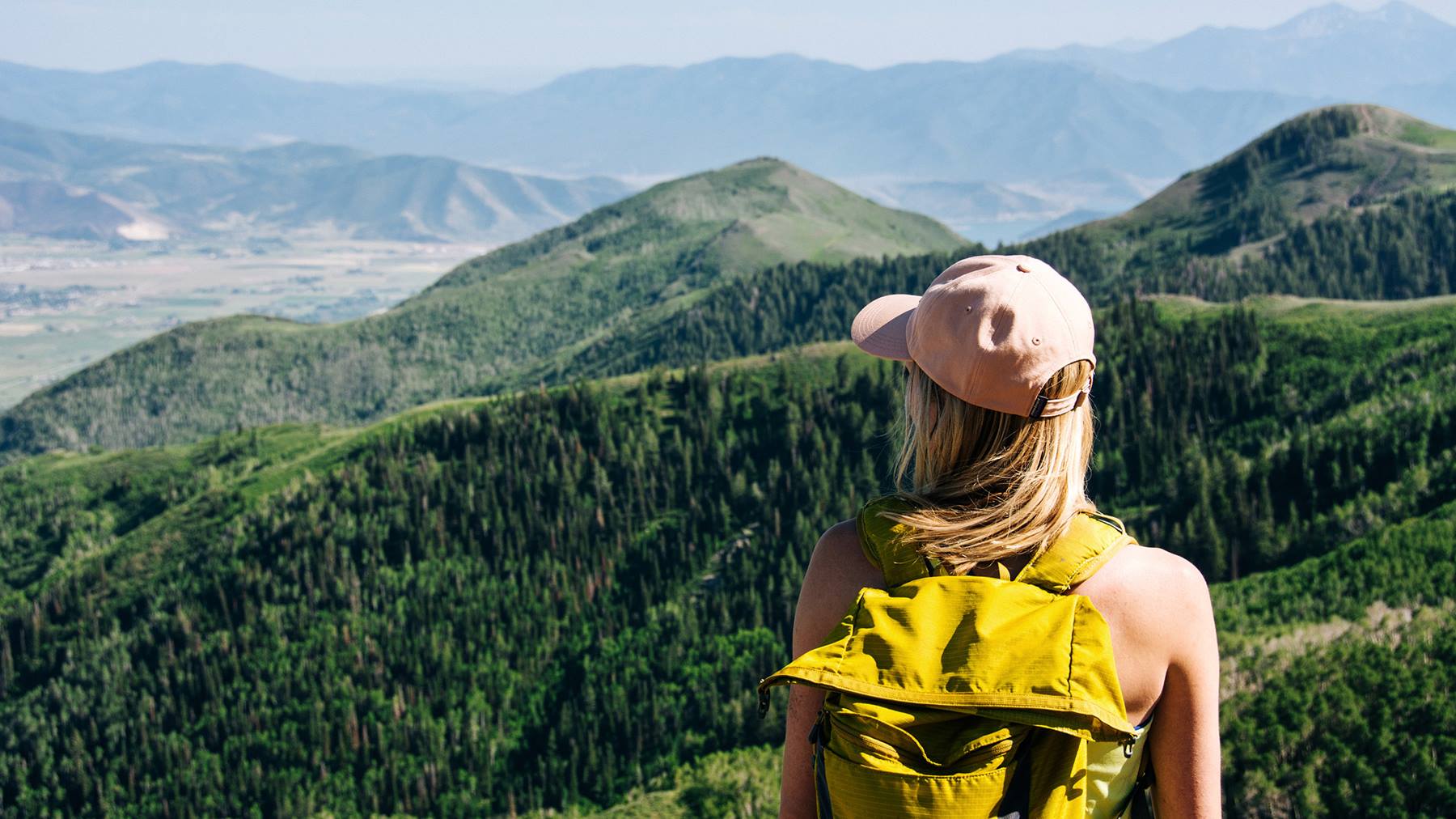 Woman hiking at Deer Valley in the summer admiring the views