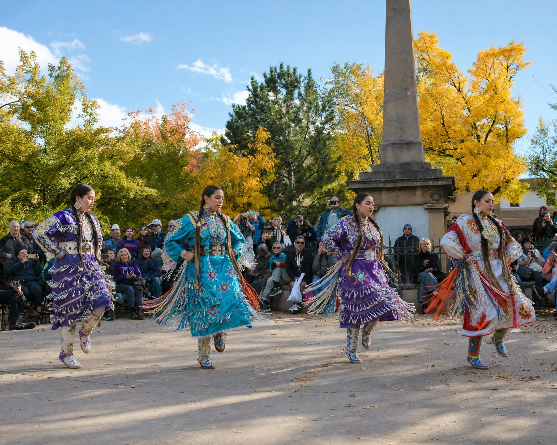 Native American dancers in colorful regalia at Santa Fe's Indigenous Peoples' Day celebration